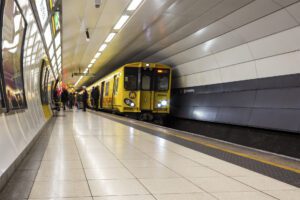 Liverpool / UK - February 22 2020: Passengers moving in a blur on and off Merseyrail British Rail Class 507 train, Moorfields station, Liverpool