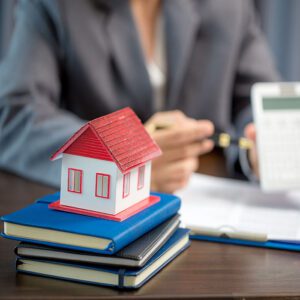 House model on a stack of notebooks