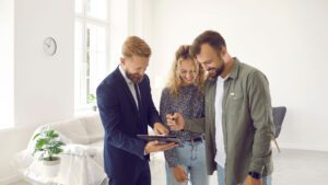 Couple signing up rental contract for property with the estate agent