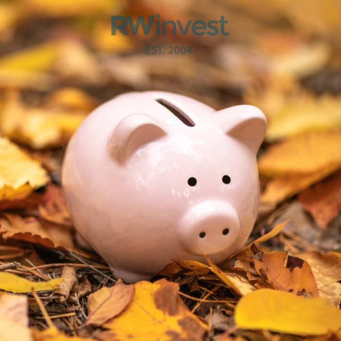 Piggy bank in fallen leaves representing the Autumn Budget